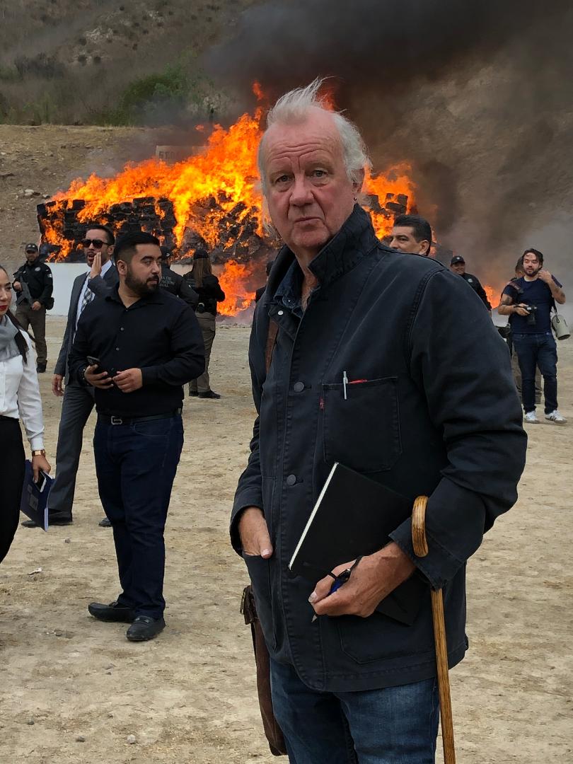 Ed Vulliamy with the Mexican government burning 26,000 tons of heroin, cocaine, meth and other drugs in the background